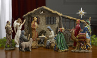 Image of all the figures in the 11-Piece Nativity Set from St. Jude Shop on display inside of a stable.