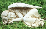 A stone angel sleeping in a bed of grass and clovers