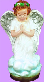 A small kneeling angel figurine in color wearing a green crown on a purple background. 