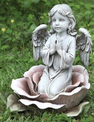 Angel kneeling in a rose garden statue. This gorgeous statues features a little angel kneeling in the center of a rose with her hands together in prayer. This statue can make a beautiful addition to your outdoor space.  Dimensions: 11"H x 9.25"W x 9"D. Resin and stone mix