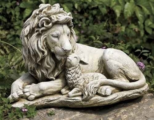 Statue of a lion and a lamb laying together.