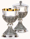 Silver Chalice ~ Ht. 6 ¾” ~ 14 oz. with 5 7/8” bowl paten.  Engraving Available
B-4134S Ciborium with hand engraved silver accents symbolizing the Apostles
Host Capacity 180, Height 8 1/4" Made of high quality brass
Silver Plated with 24k gold lined cup
Inside of ciborium cup lined in 24k Gold. Includes Ciborium Lid with C
Made in USA
