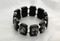 Popular Brazilian Wood Stretch Bracelet. Portrays black and white images of popular Saints and visions of Our Lady. 3/4" Black Wooden Rectangular Shape separated by Beads. 

 