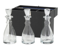 Image of three clear glass chrismal bottles with glass stoppers.