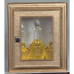 Ambry-22 - Plexiglass window. Bronze face. Dimensions: 12" H X 10" W. Stainless Steel box 11" H x 9"W x 4"D. Bottles shown (K71) not included