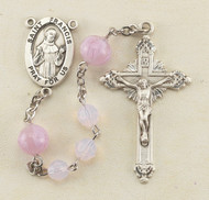 6mm Pink Opal Swarovski Crystal Beads with 8mm Pink Venetian Rosebud Our Father Beads. Centerpeice is a sterling silver St. Agatha. Crucifix measures 1-3/4".  St Agatha Rosary comes in a deluxe velour gift box. Made in the USA