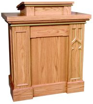 Pulpit with gothic trim columns, extended shelf for lamp and microphone. Two inside shelves for storage. Measures 40"w x 24"d x 46"h. Book rest measures: 24"W x 21"D. Please double click color chart to select wood color