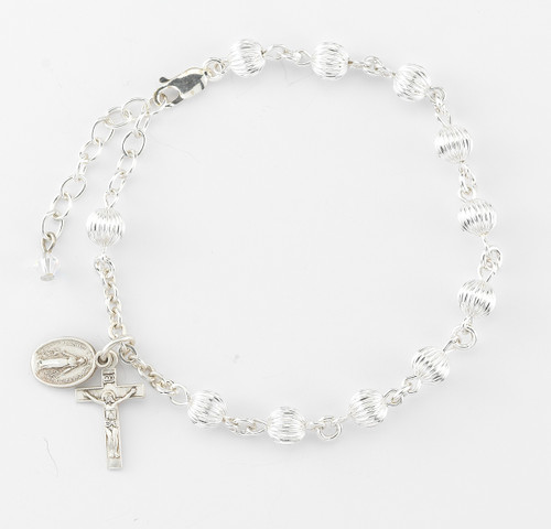 6mm Rosary Bracelet with Herringbone Corrugated Round Sterling Silver Beads. Sterling silver Miraculous Medal and Crucifix. Comes in a deluxe velour gift box. Made in the USA.