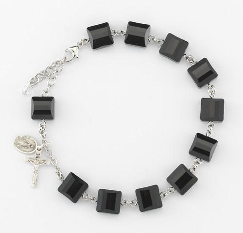 10mm Square Faceted Swarovski Jet Black Beads rosary bracelet.10mm Square Faceted Swarovski Crystal Beads rosary bracelet. Bracelet comes with Sterling Silver Miraculous Medal and Crucifix. Bracelet is available with sterling silver links or rhodium plated brass links. Comes in a deluxe velour gift box. Made in the USA