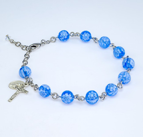 8mm Blue Flower Venetian Glass Beads with Miraculous Medal and Crucifix. Choose from:
BX:  Solid Brass Links with Pewter Miraculous Medal and Crucifix; or
BR: Rhodium Plated Brass links with Sterling Silver Miraculous Medal and Crucifix; or 
B: All Sterling Silver Links,Miraculous Medal and Crucifix.
Bracelets come with deluxe velour gift box. Made in the USA.