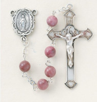 Rosary with 6mm round genuine rhondonite beads. Sterling Silver Miraculous Center and a 1-3/4" Sterling Silver Crucifix with Rhodium Plated Findings. Comes with a deluxe velour gift box. Made in the USA.