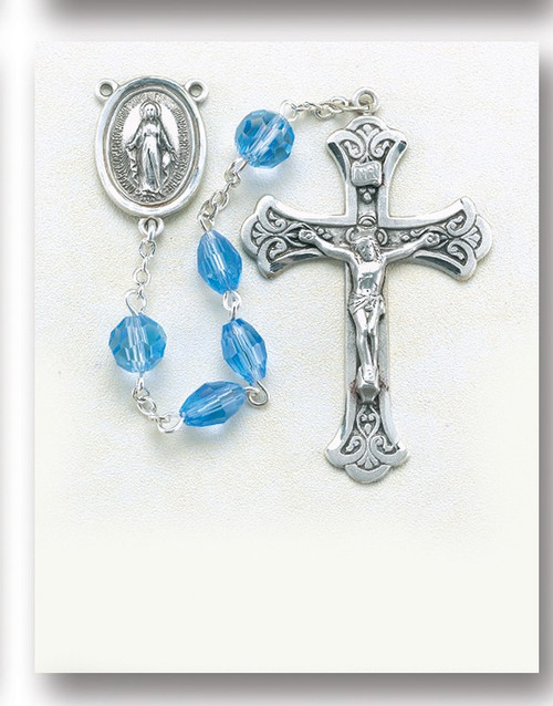 Light Sapphire-5mm Light Sapphire Multi Faceted Oval Tin Cut Crystal Beads with 8mm Round Faceted "Our Father" Beads. Sterling Silver Miraculous Center and 2-1/8" Sterling Silver Crucifix with Rhodium Plated Findings. Comes with a deluxe velour gift box. Made in the USA. 