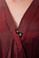 Detail of front snap on Gina - saloncapes.com's High Performance, Iridescent Polyblend Wraparound Client Kimono in Burgundy