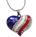 Heart shaped patriotic pendant with silver-plate stars on a blue background. Diamond-like crystals decorate a white background and a red enamel stripe. Front view.