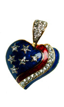 Gold-plate, enamel with Swarovski crystal stars and ribbon in the shape of a heart. Size: 1.25"H x 1.75"W.