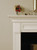 The clean detailed lines on the legs that cross into the corner frame compliment the fireplace.