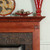 Neatly designed block trim and dentil molding are enhancers for the wood fireplace mantel.
