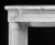 Bead design trims the circular patter in the header of the marble mantel.