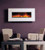 A beautiful white limestone fireplace facing allows this electric fireplace to fit well with almost any decor.