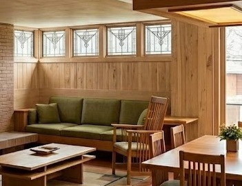 The back wall features a continuous stretch of light-toned, vertical wood paneling that highlights soft grain variations and subtle character knots.