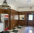 A nostalgic, retro-inspired commercial space, community breakroom, or recreation hall that captures a mid-to-late 20th-century Americana vibe. The room is currently undergoing partial renovation or finishing work, pairing vintage elements like wood paneling and a checkered floor with traditional fixtures.