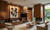 An expansive, high-end Mid-Century Modern living room that masterfully blends organic warmth with clean, architectural lines. The space showcases extensive, floor-to-ceiling Spirit Birch wood vertical paneling that integrates the entire room into a cohesive, warm, and sophisticated functional zone.