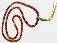 Amber mala with natural, fine-quality 7mm beads and red coral resting bead spacer and Turquoise bead spacers. Capped  with a Turquoise guru bead capped in silver.