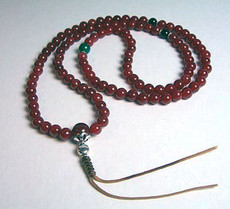 Carnelian natural stone Mala crafted from 8 mm beads, then strung on a strong, durable cord, with 2 Black Onyx stone spacers and a cut Green Jade stone spacer in between sterling silver rings.