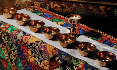 Offering bowls are used on shrine tables for making water offerings expressing generosity.  Set includes a butter lamp. Perfect for your shrine table to make water offerings.