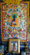 Medicine Buddha Thangka image on shrine where healing, health and prosperity puja is performed for the benefit of others.