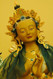 Green Tara statue with robe and jewels in crown bestowing blessings